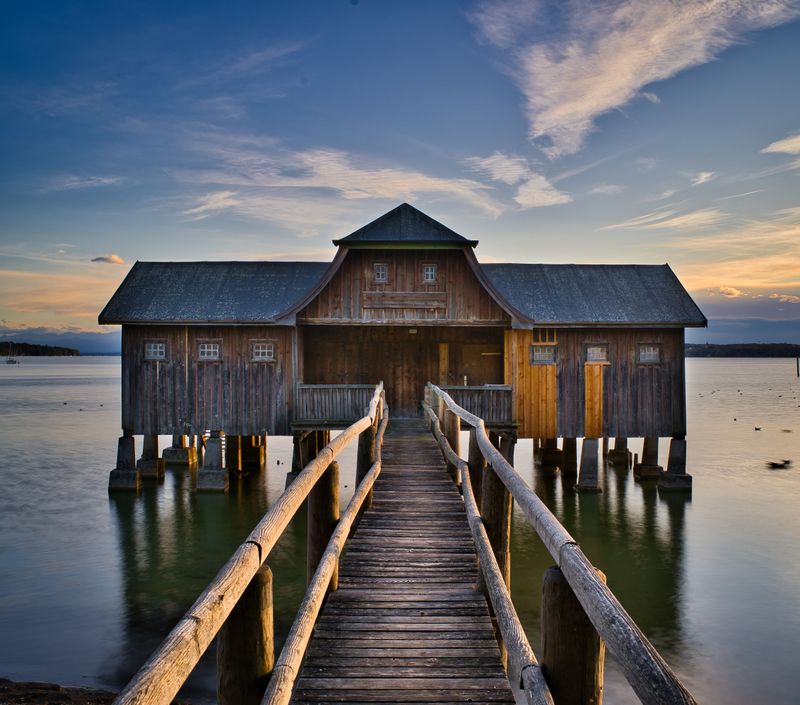 A wooden boathouse at the end of a pier — Denis Ba on Pexels