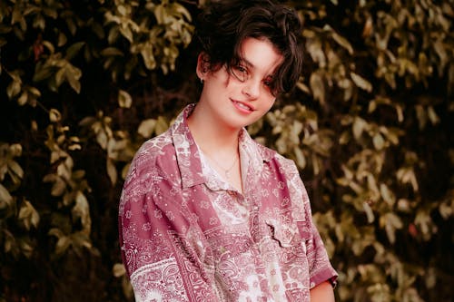 A Smiling Woman Wearing a Printed Shirt