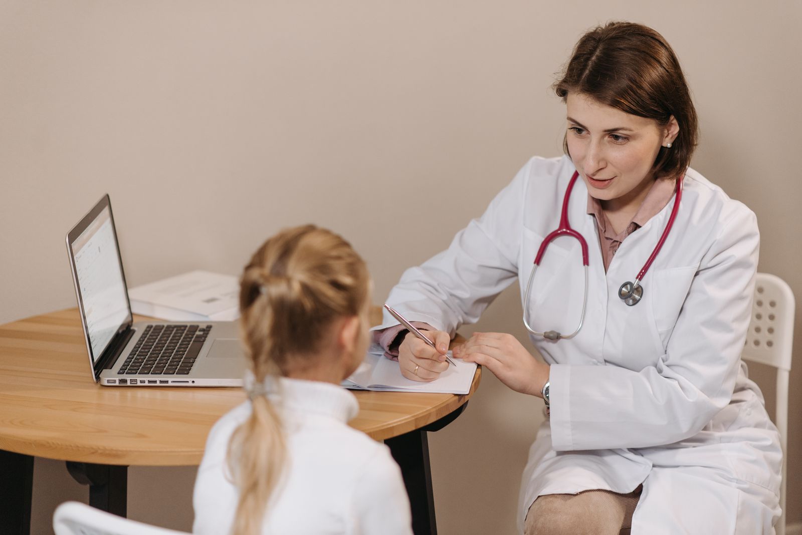 Paediatrician speaking with a young patient