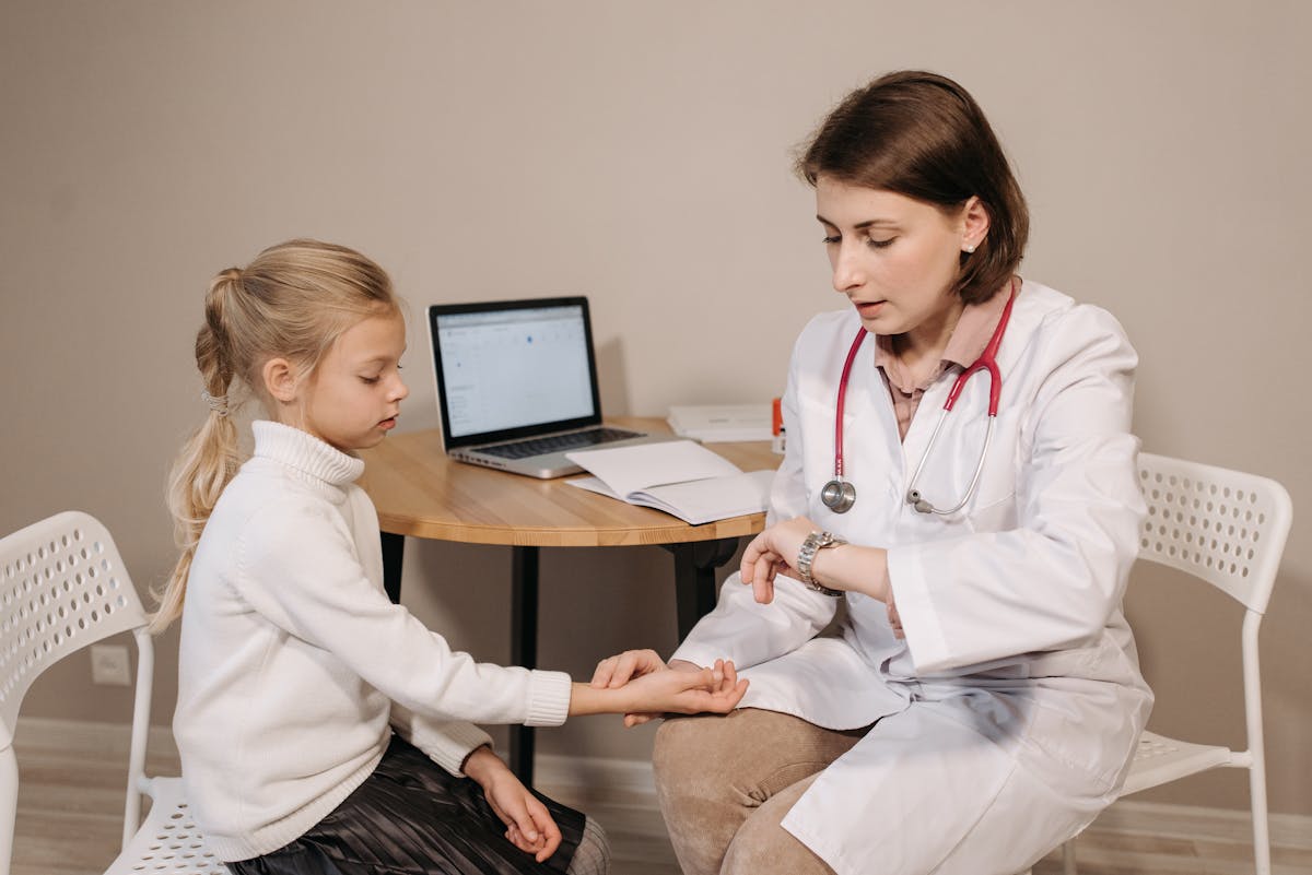 Person holding their lower back in pain while reviewing medication options on a table