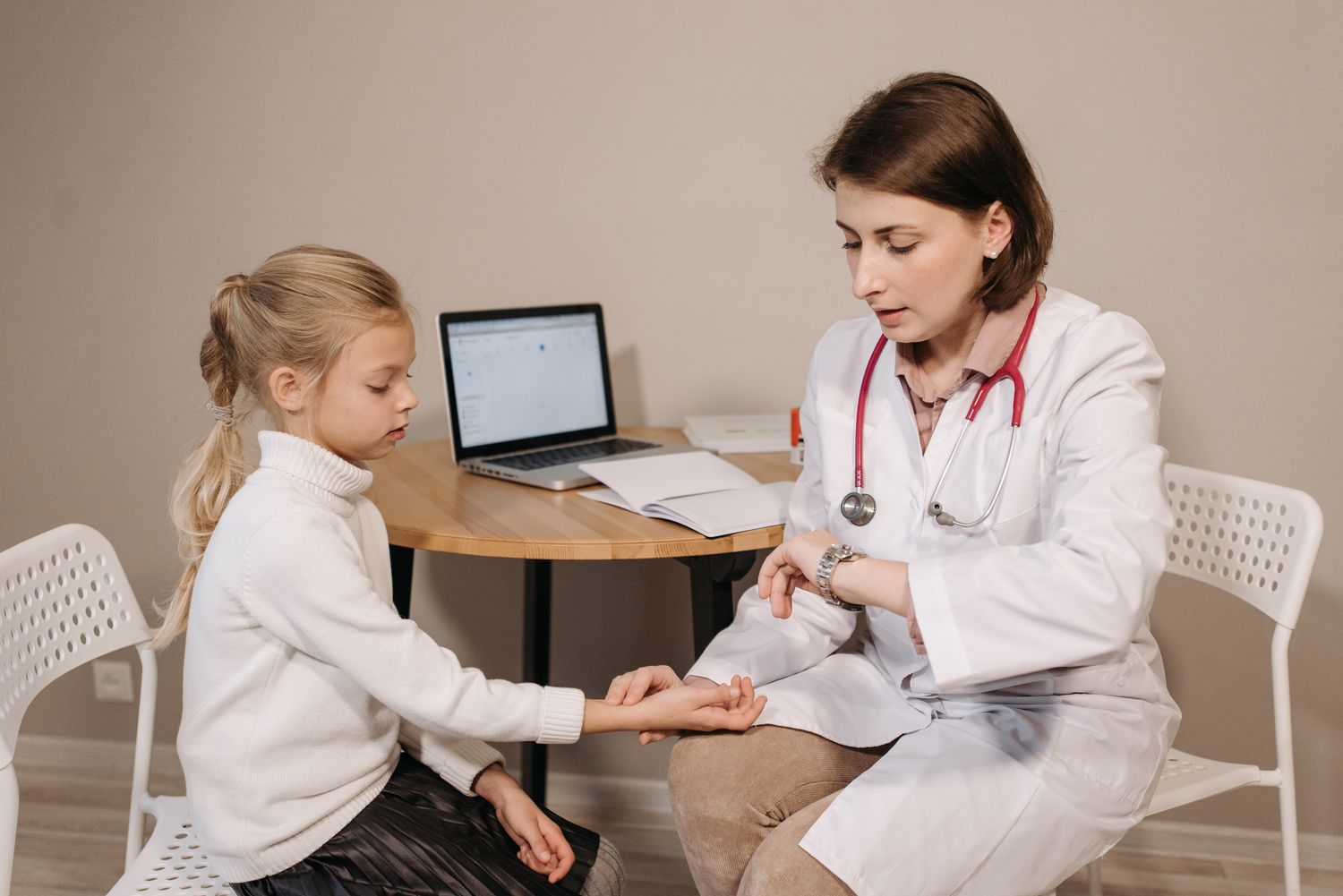 A doctor listening carefully during a child's medical consultation