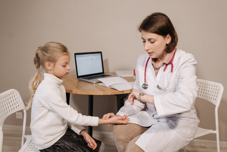 A Doctor Examining A Child Patient