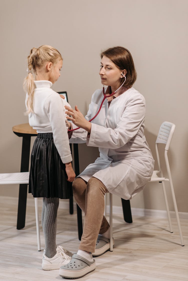 A Doctor Examining A Child Patient