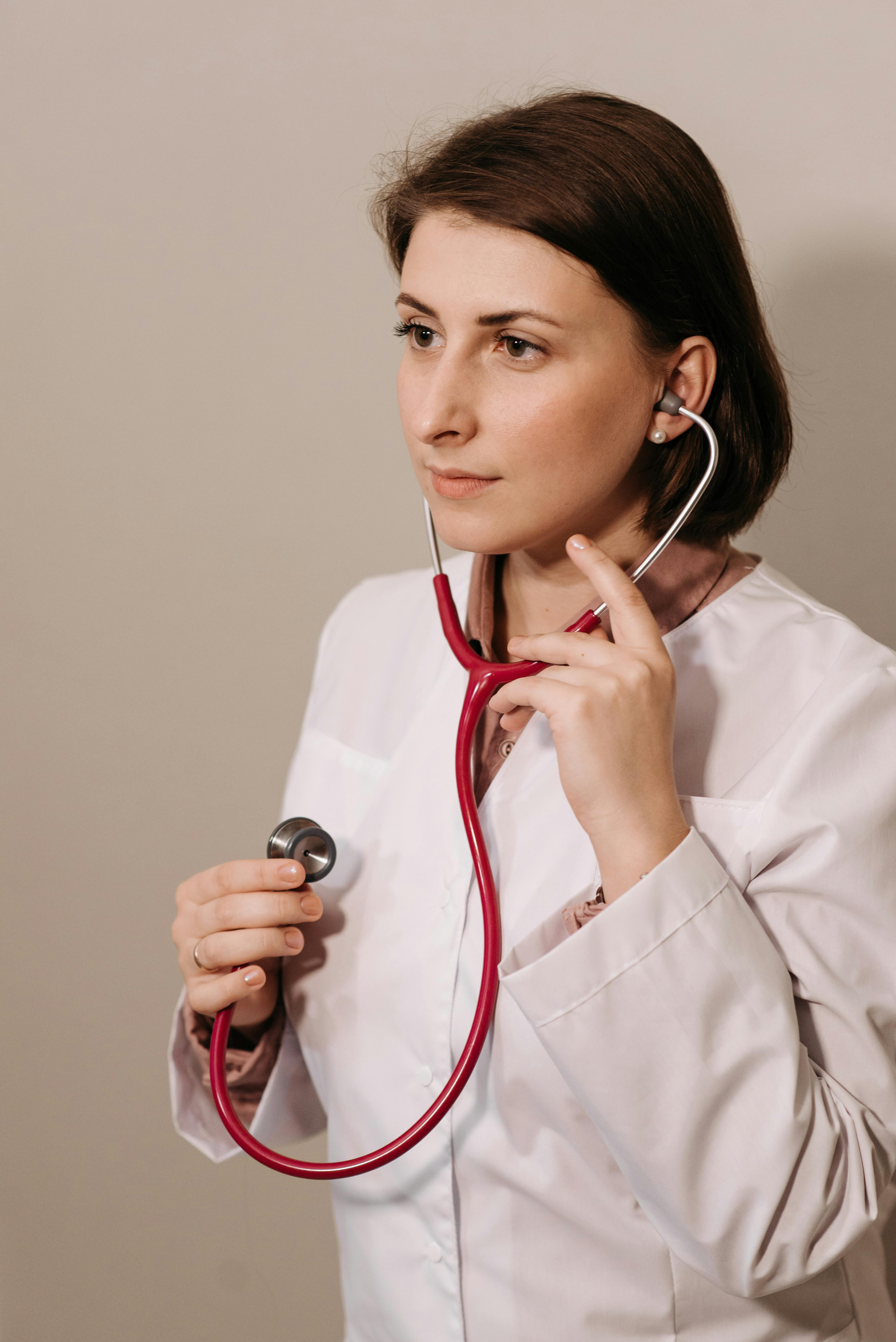 woman in lab coat wearing a stethoscope