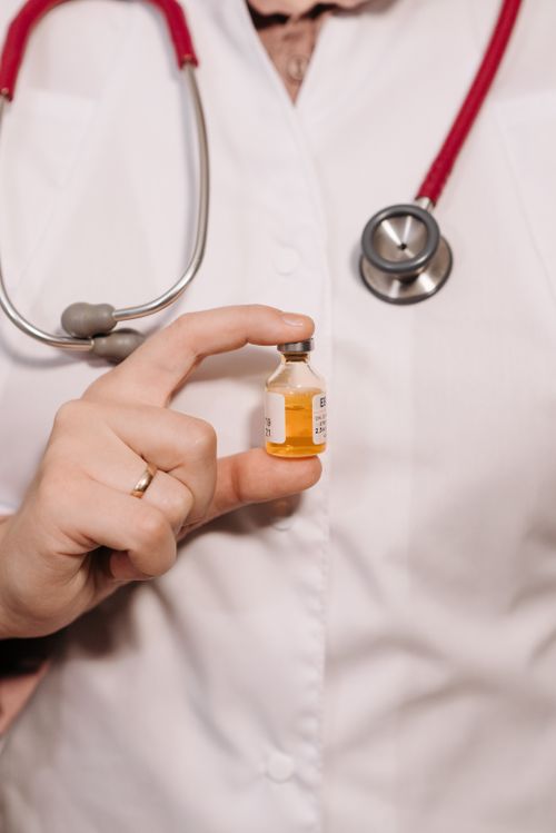 Free Close-up of healthcare worker holding a vaccine vial, emphasizing medical care. Stock Photo
