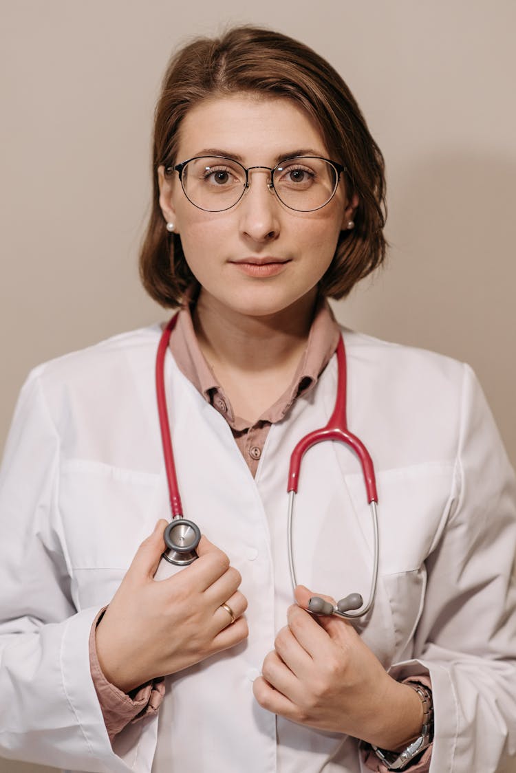 Physician In White Coat Wearing A Stethoscope