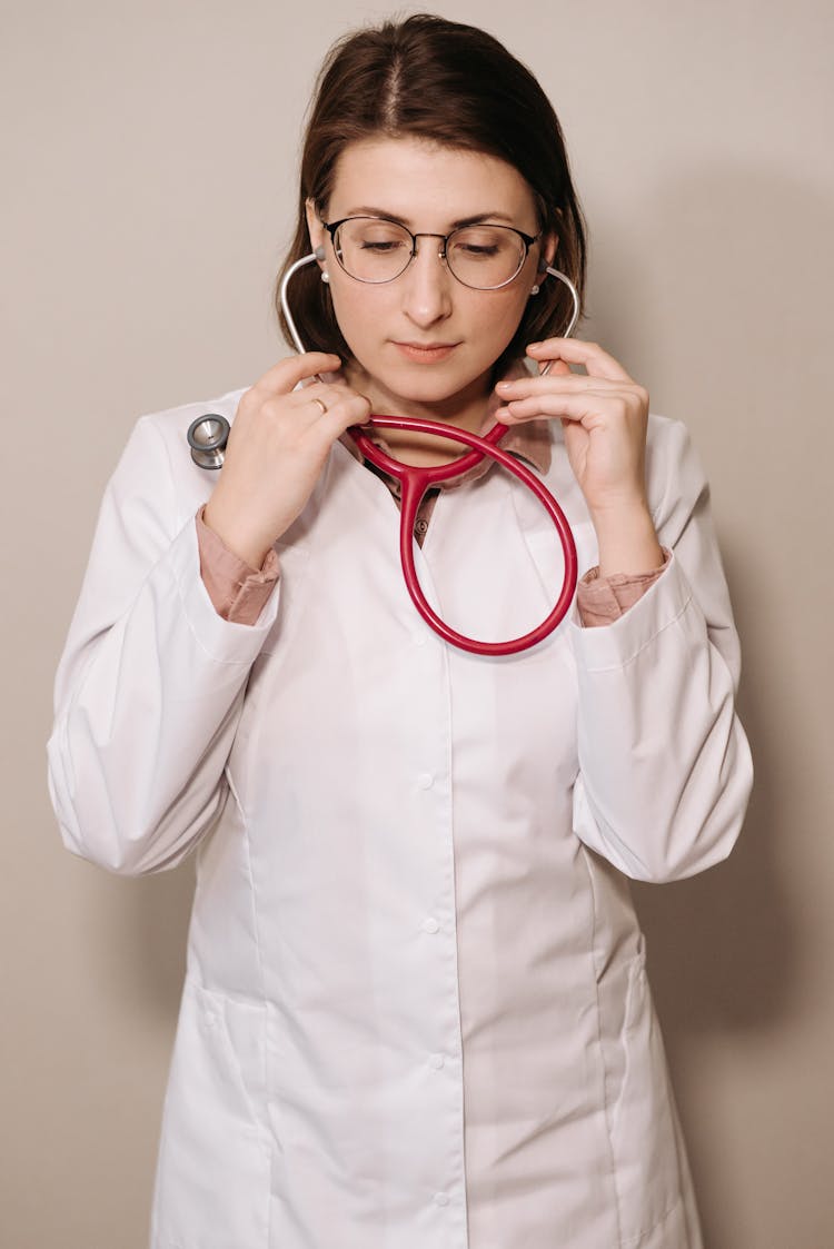 Physician In White Coat Wearing A Stethoscope