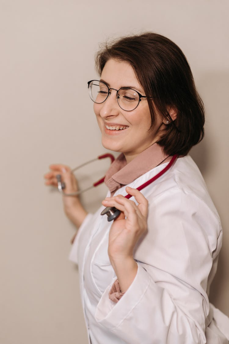 A Smiling Physician In White Coat Wearing A Stethoscope