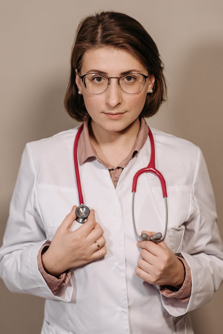 Physician In White Coat Wearing A Stethoscope