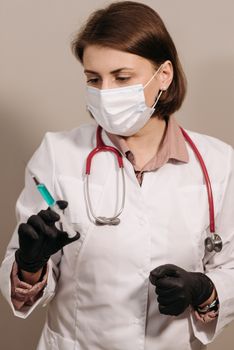 Doctor in PPE with syringe and stethoscope, poised for vaccination.