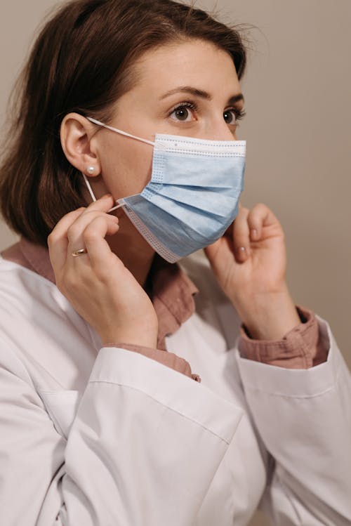 A Physician Wearing a Blue Face Mask