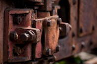 Blurry Photography of Red Metal Auto Part