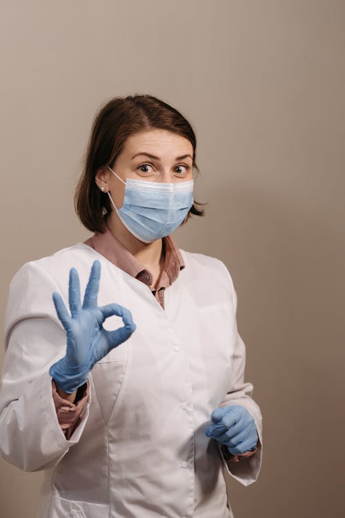 Physician Wearing PPEs while Doing an OK Sign