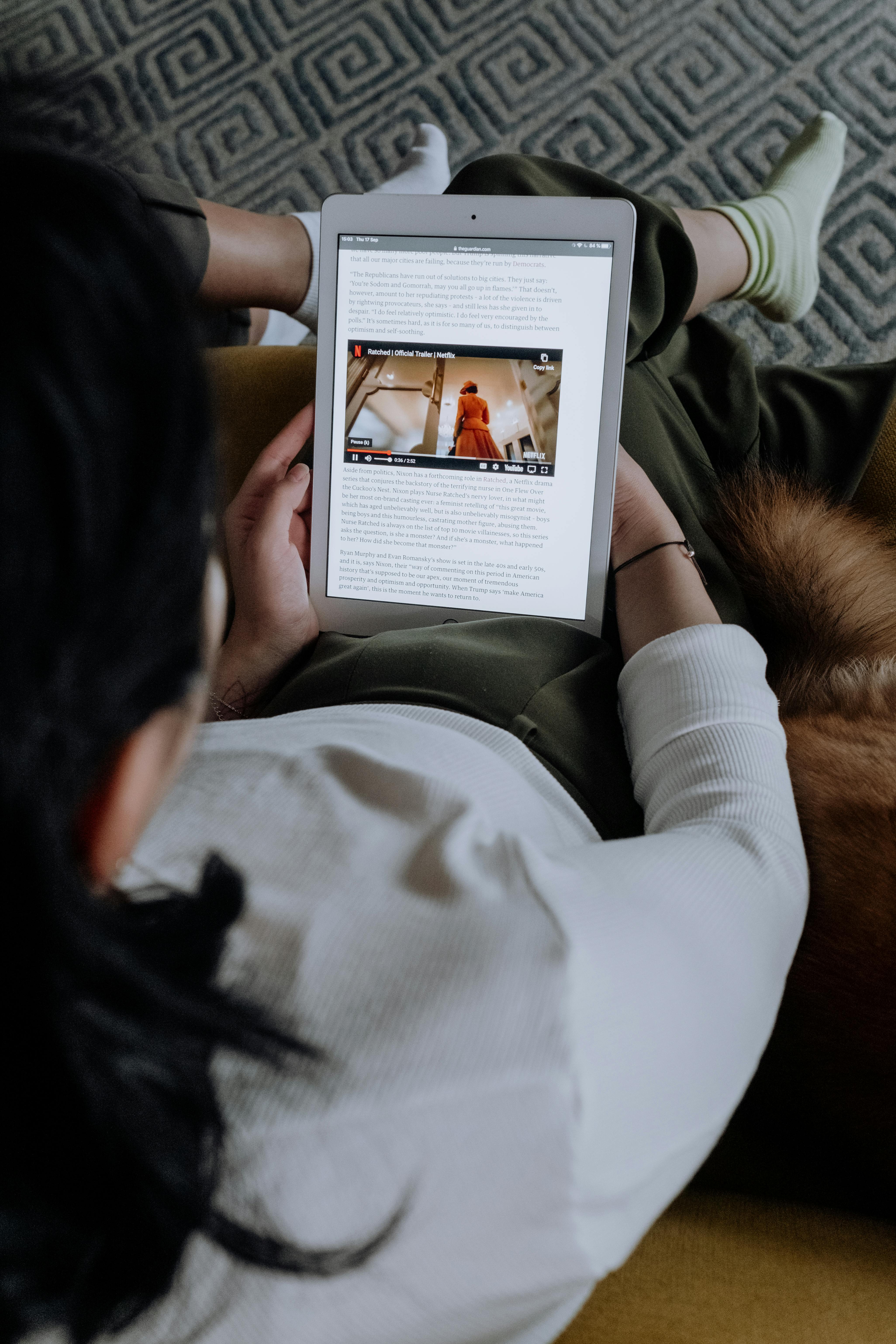 woman in white long sleeve shirt holding a tablet