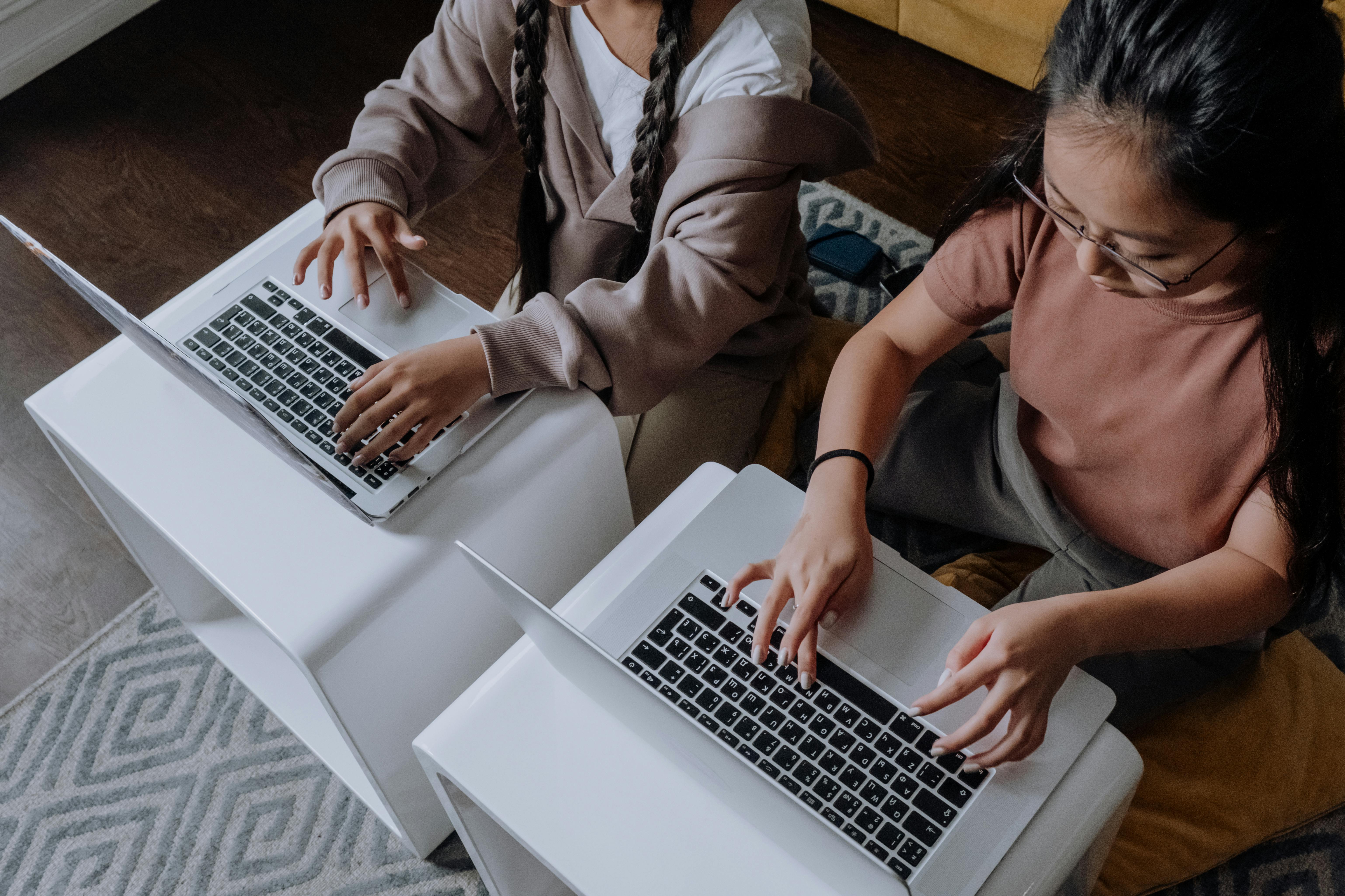 Woman in White Blazer Using Macbook Air