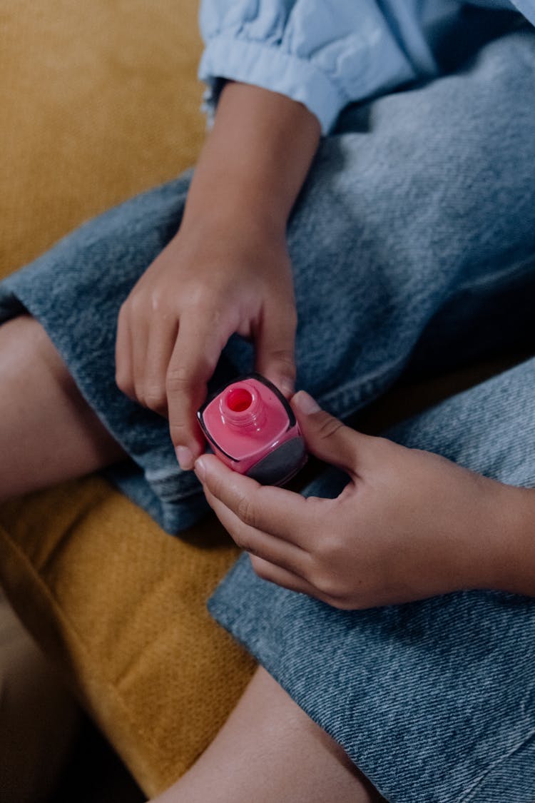 A Person Holding A Nail Polish Bottle