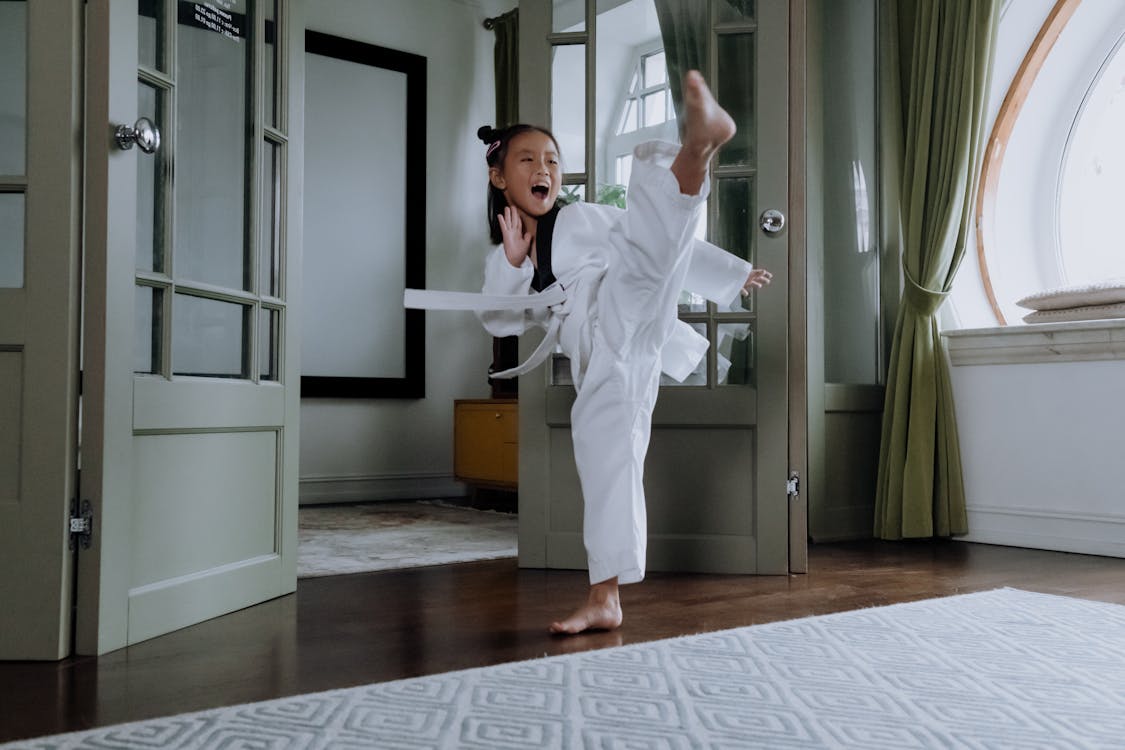 Woman in White Scrub Suit Standing on Brown Wooden Parquet Floor