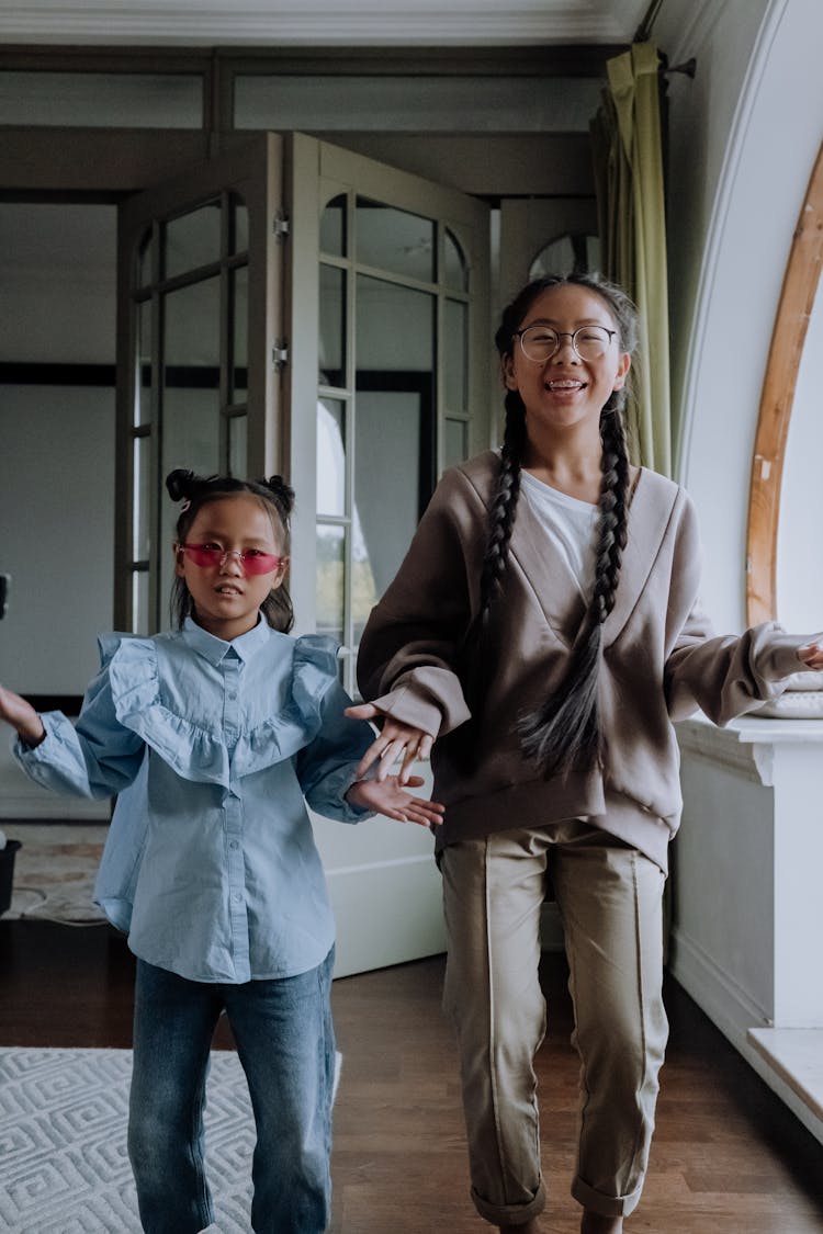 Young Girls Dancing While Smiling