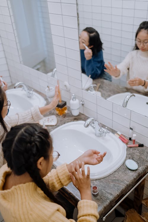 A Girl Putting Makeup on Her Hand