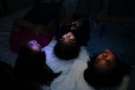 Woman in Black Shirt Lying on Bed