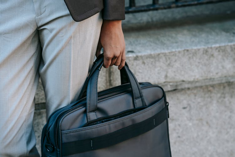 Crop Entrepreneur With Laptop In Bag