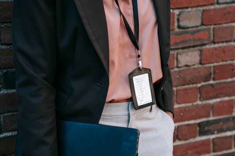 Crop Person With Badge And Laptop