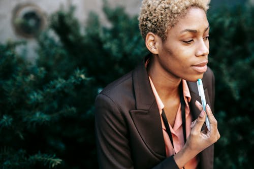 Thoughtful black businesswoman working in park