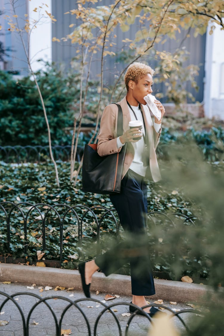 Black Businesswoman Eating While Hurrying