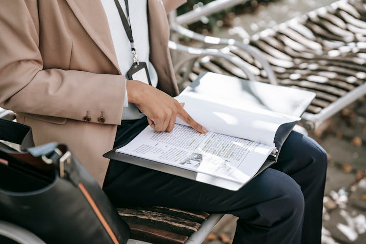 Crop Woman Reading Text On Paper