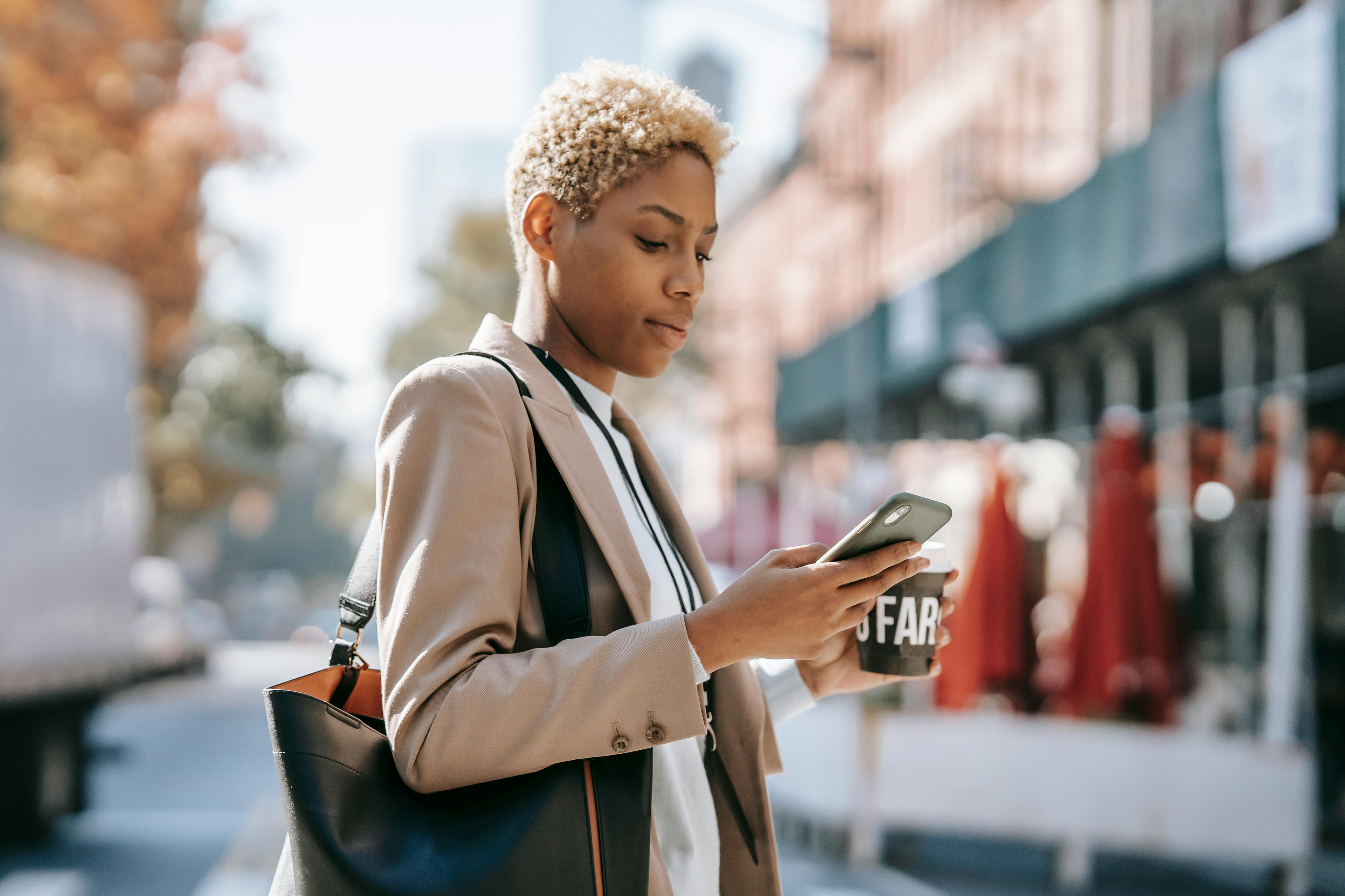 focused woman messaging on smartphone