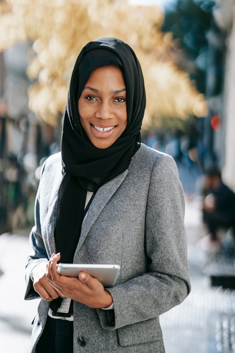 Smiling Black Female Manager With Tablet On City Street