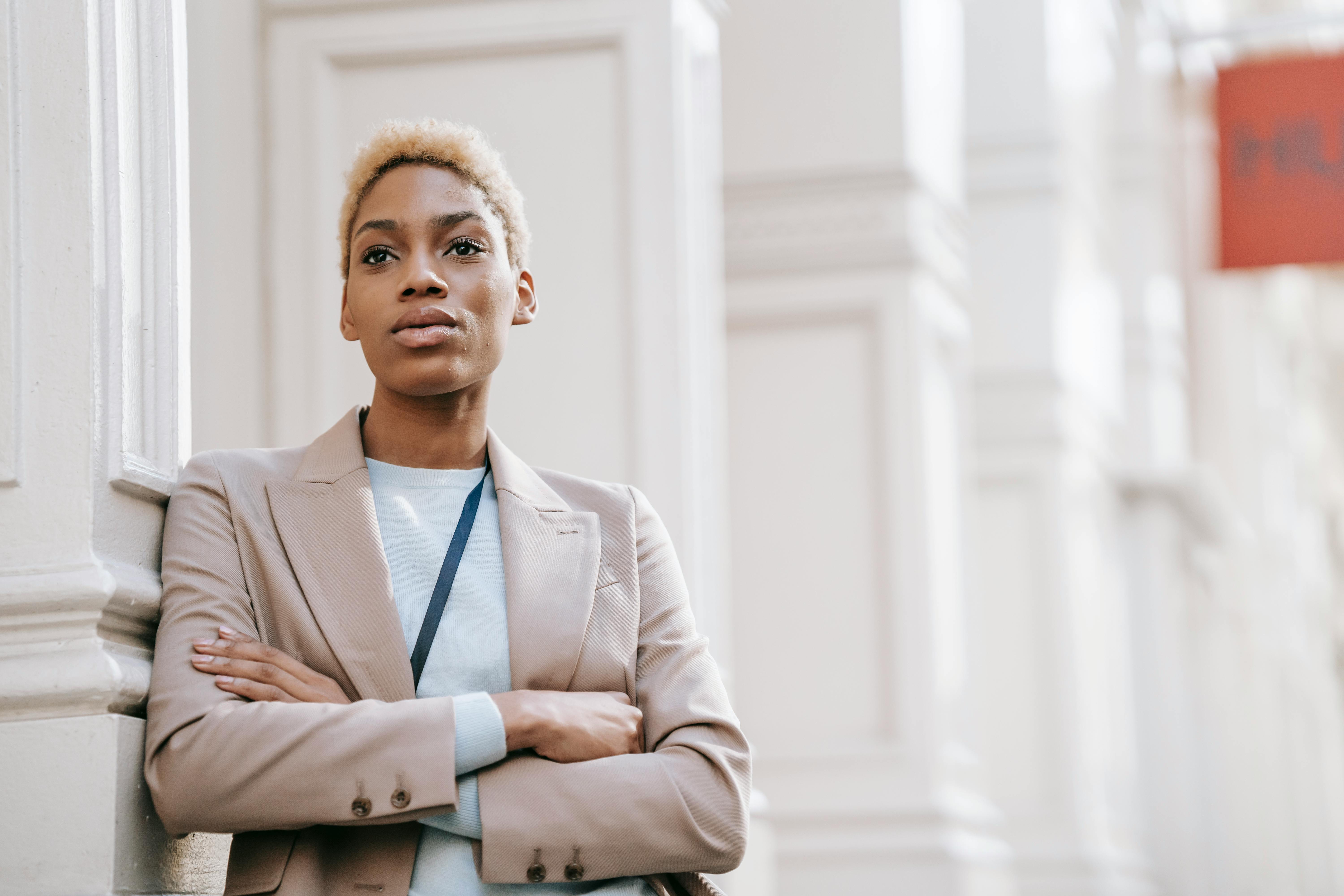 confident black businesswoman with crossed arms in town