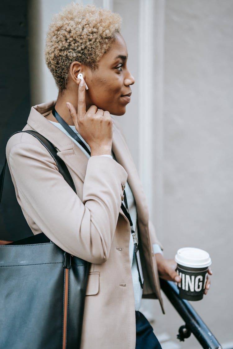 Dreamy Black Manager With Earbud And Coffee To Go Outdoors