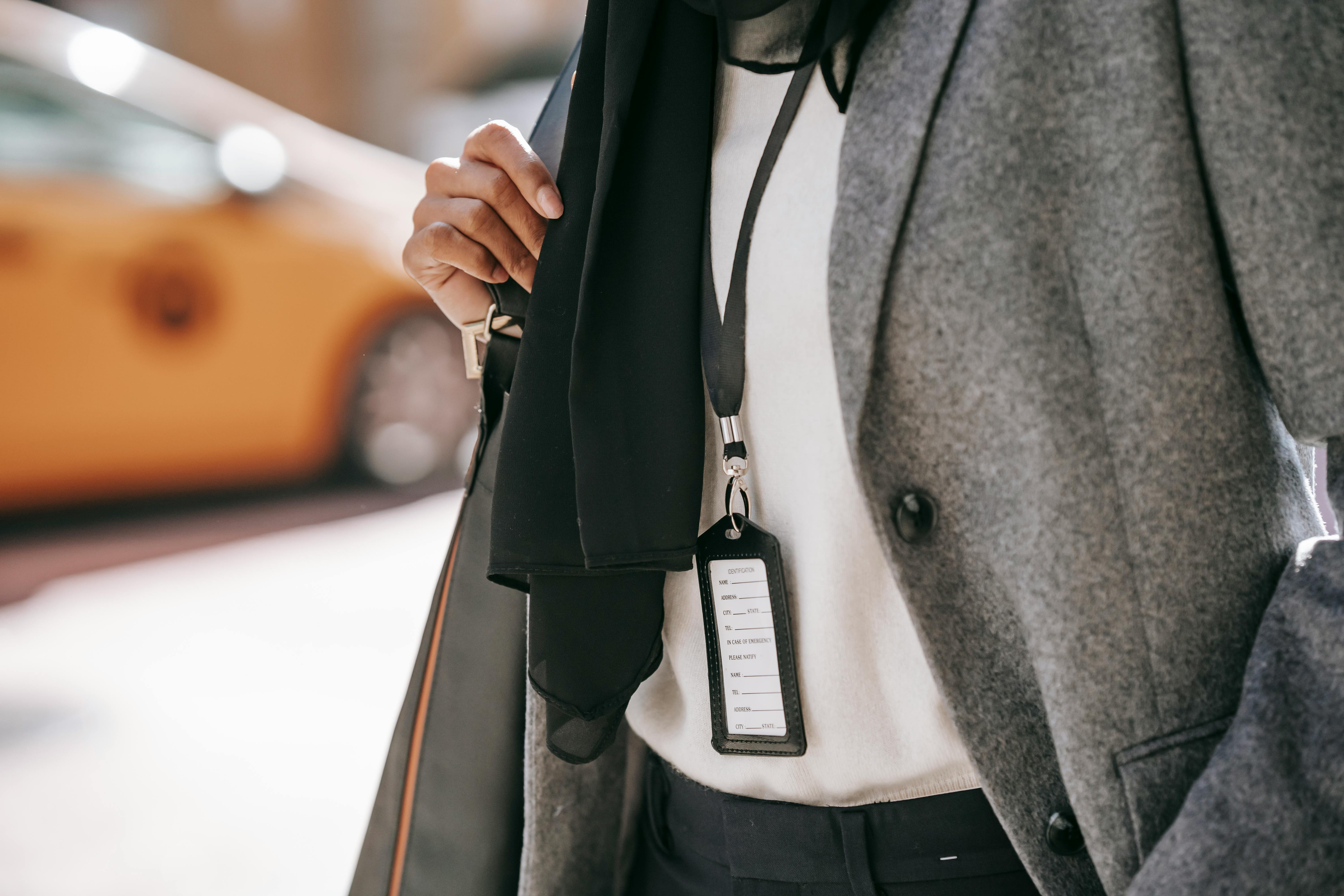 anonymous stylish businesswoman walking on city street