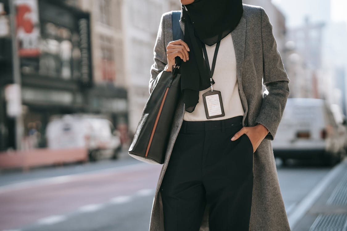 Free Trendy Muslim businesswoman standing on city street Stock Photo