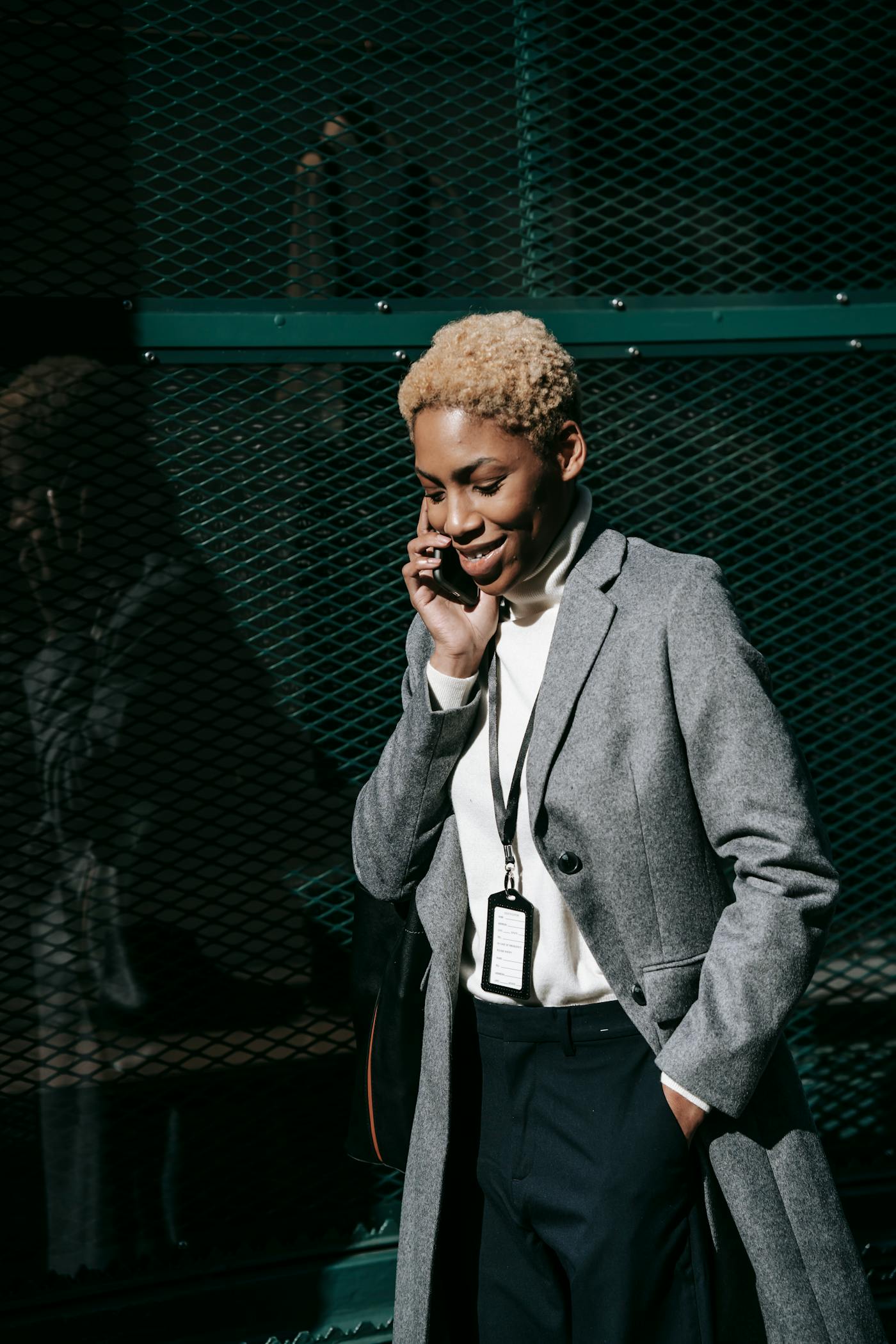 Black professional reading a message on her phone in an urban setting