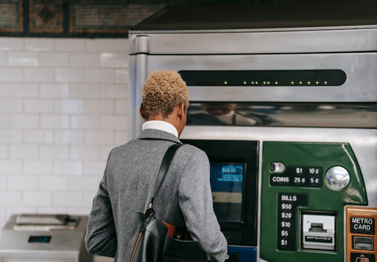 Anonymous Black Woman Standing Near Metro Ticket Machine