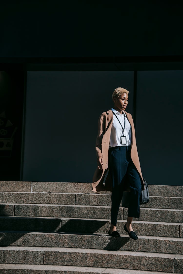 Young Ethnic Businesswoman Walking Down Stairs