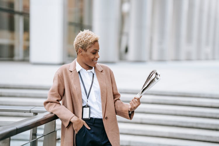 Happy Black Businesswoman Reading Newspaper