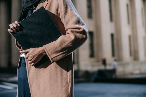 Person in Brown Coat Standing on Sidewalk