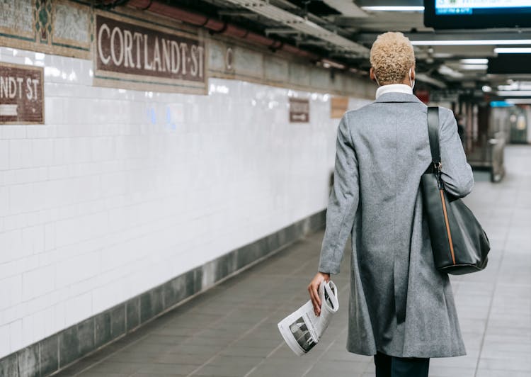 Anonymous Elegant Ethnic Female Walking In Underground Corridor