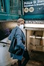 Serious black woman in mask entering subway station