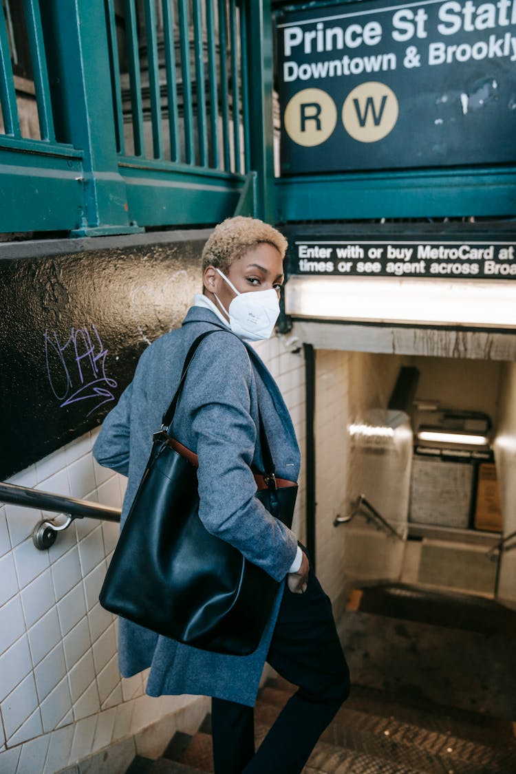 Serious Black Woman In Mask Entering Subway Station