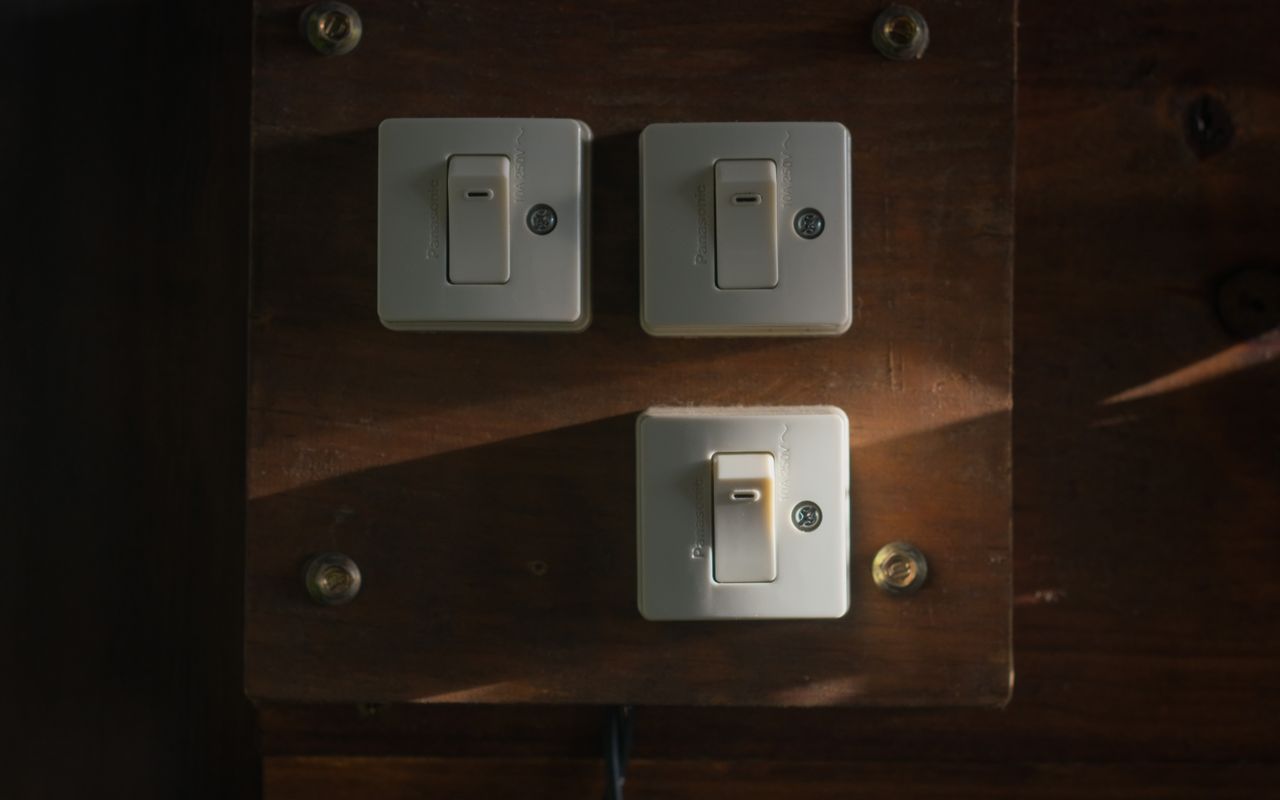 Vintage light switches on dark wood panel