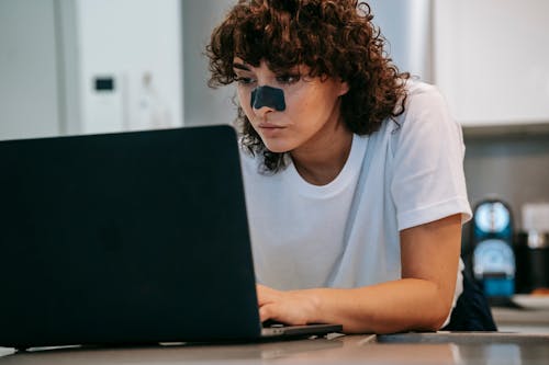 Focused woman using laptop at home