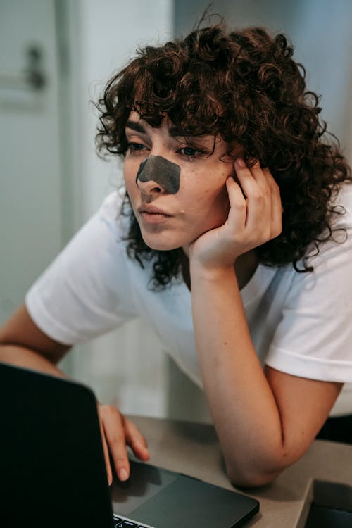 Concentrated female employee working on laptop at home