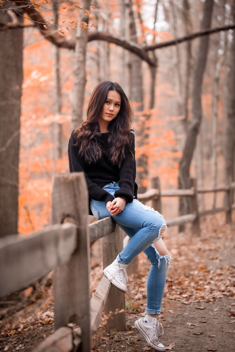 Woman in Black Sweater Sitting on Wooden Fence · Free Stock Photo