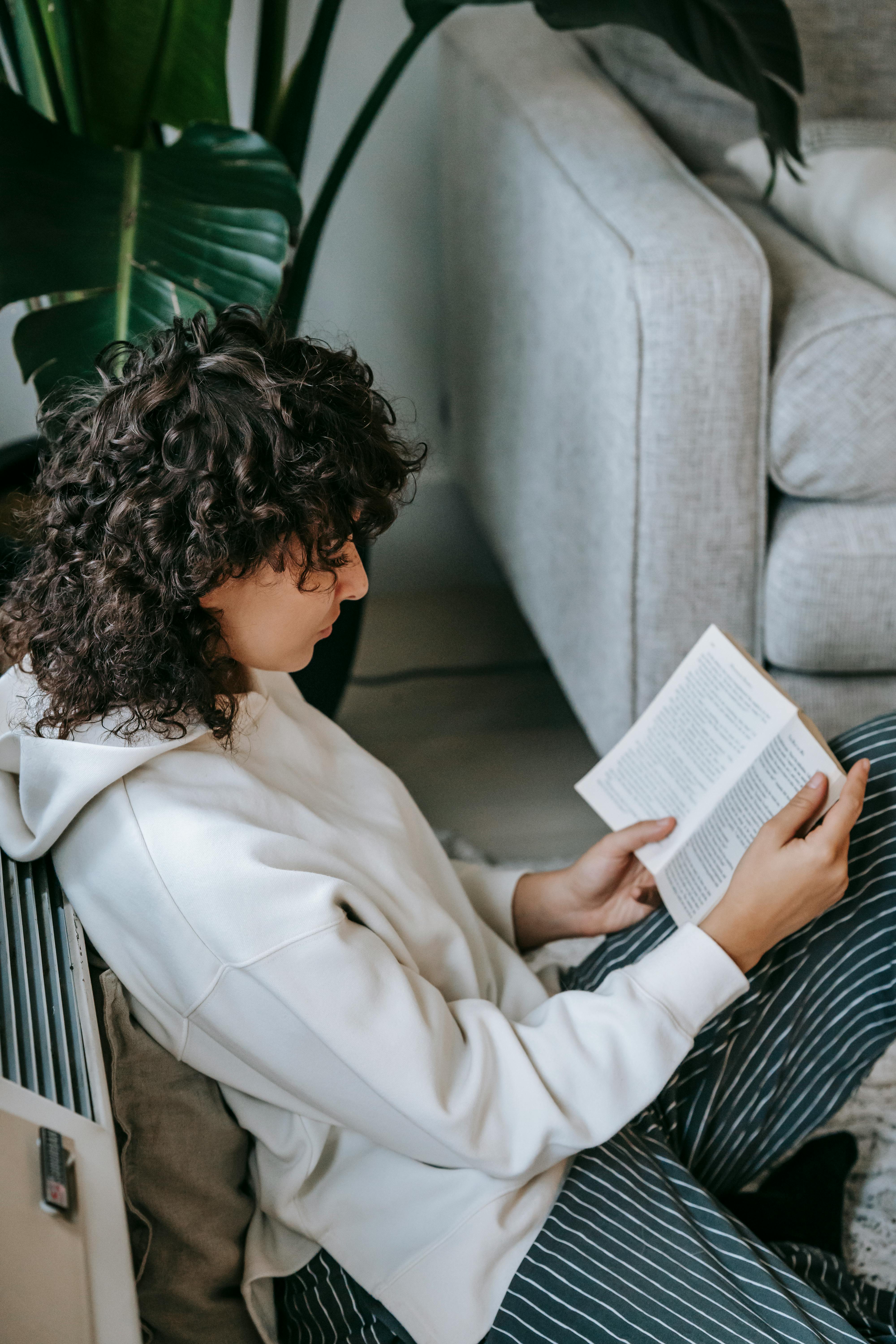 relaxed woman reading book in living room