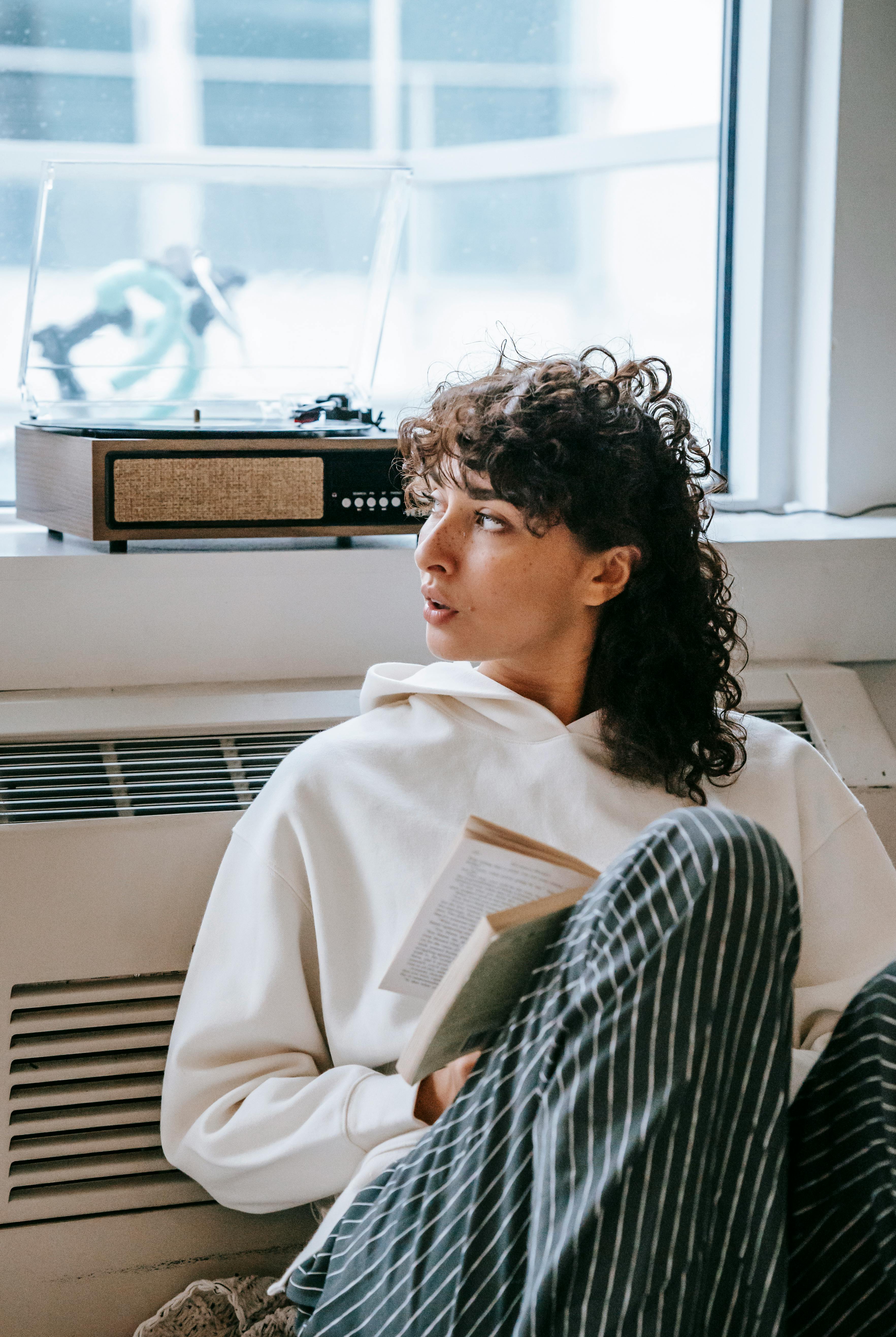 serious female with book attentively looking away