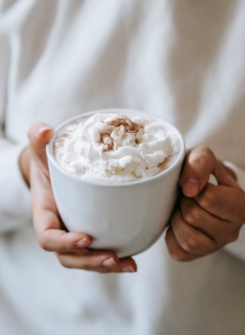 Free Woman with mug of coffee with whipped cream Stock Photo